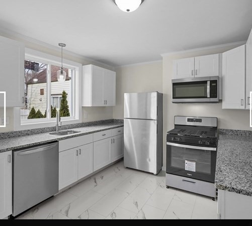 28 Borden Street, Unit 1 New Bedford, MA 02740 - Photo 3 of 11 a kitchen with a sink stove and refrigerator