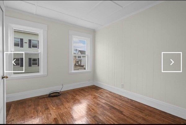 28 Borden Street, Unit 1 New Bedford, MA 02740 - Photo 8 of 11 a view of an empty room with wooden floor and a window