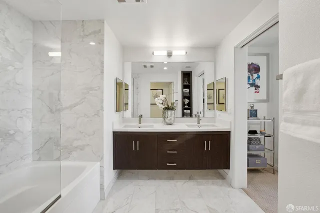 a bathroom with a tub sink and mirror
