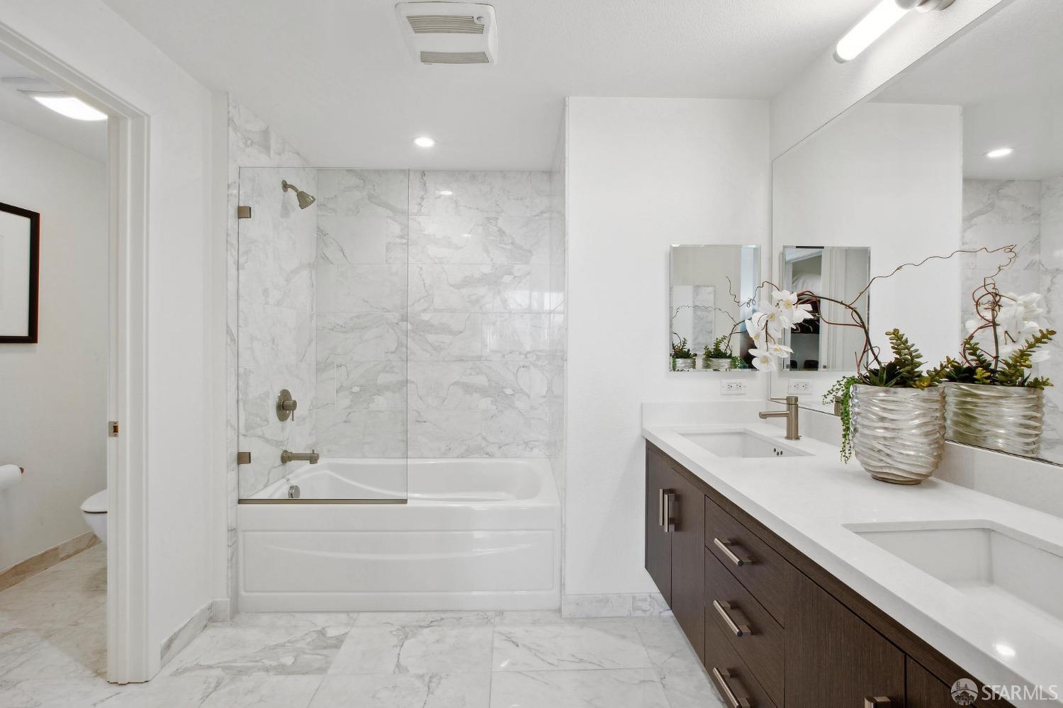 2655 Bush Street, Unit 603 San Francisco, CA 94115 - Photo 12 of 36 a bathroom with a tub sink and mirror