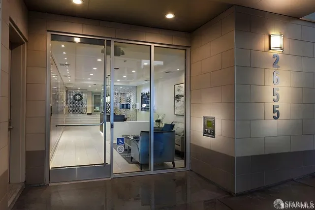 a city street lined with parked cars and buildings