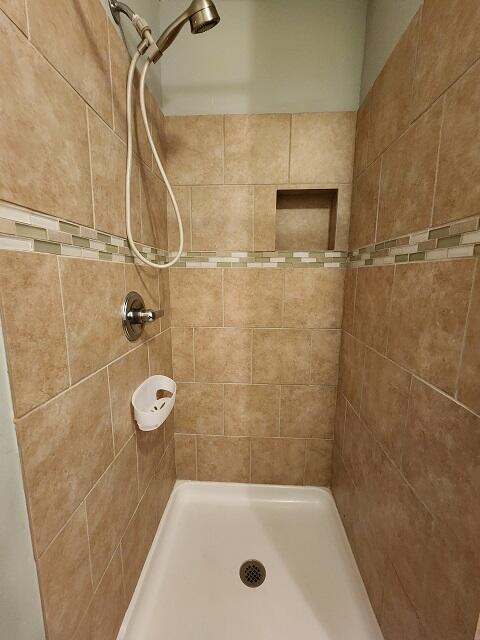 1038 37th Street Niceville, FL 32578 - Photo 15 of 25 a bathroom with a bath tub and a shower
