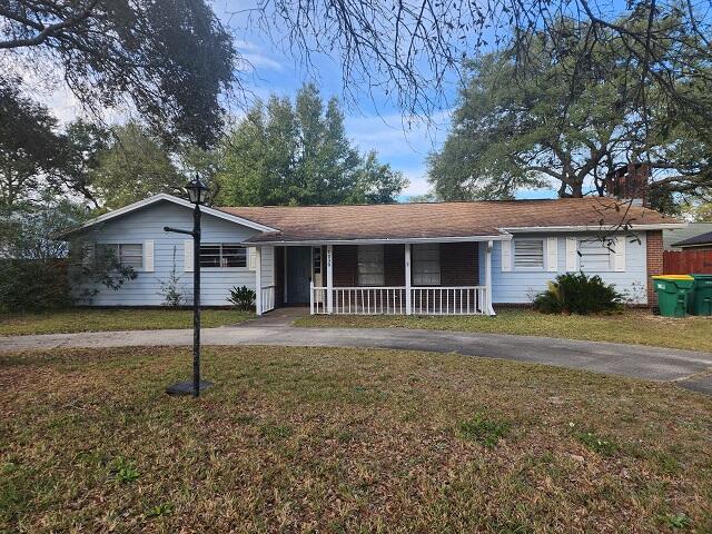 1038 37th Street Niceville, FL 32578 - Photo 2 of 25 a front view of a house with a garden