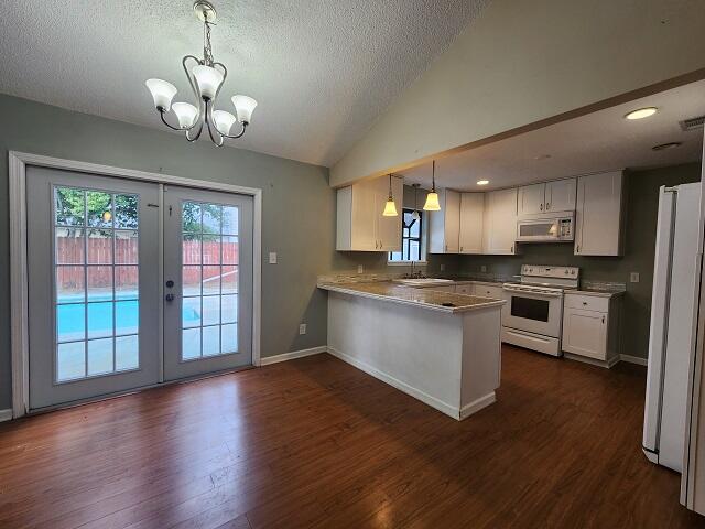 1038 37th Street Niceville, FL 32578 - Photo 9 of 25 a large kitchen with a center island wooden floor stainless steel appliances and cabinets
