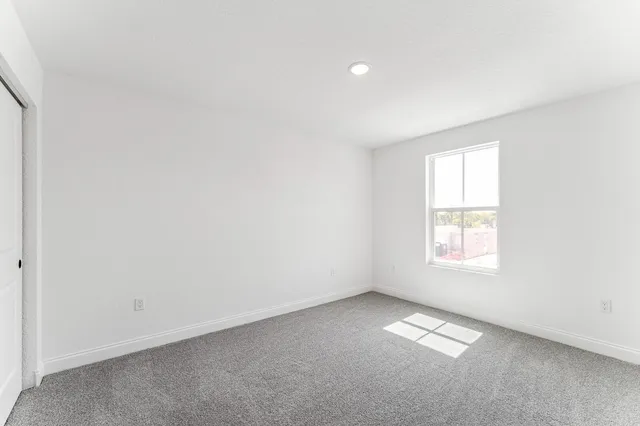 an empty room with a empty space and a window