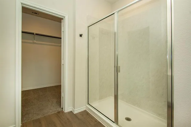 a bathroom with a glass shower door