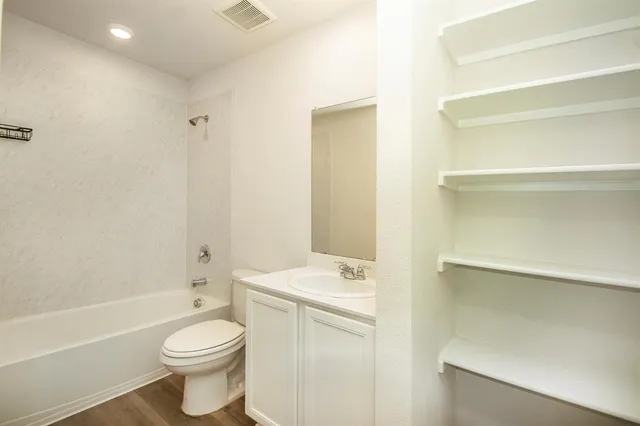 a bathroom with a sink a toilet and a bathtub