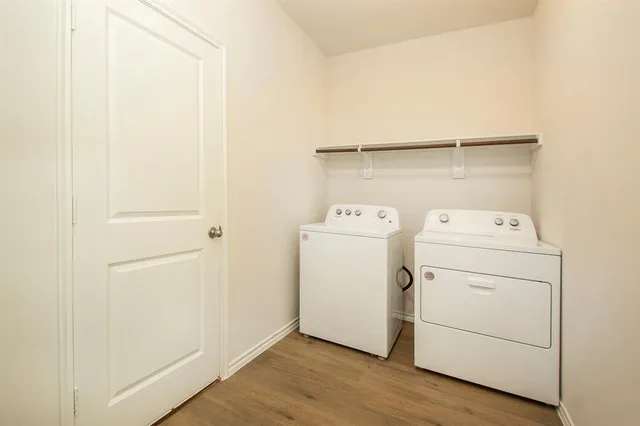 a view of washer and dryer with wooden floor
