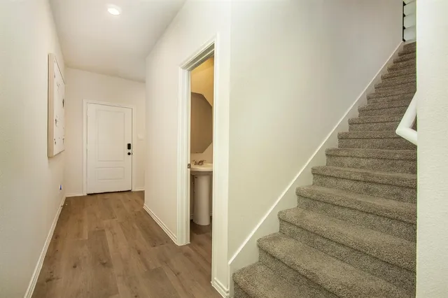 a view of an entryway with wooden floor