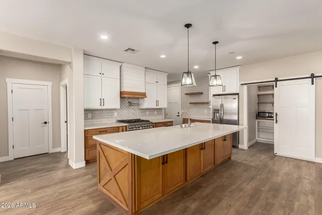 a kitchen with stainless steel appliances a refrigerator and a refrigerator