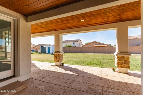 a view of empty room with wooden floor and ceiling fan