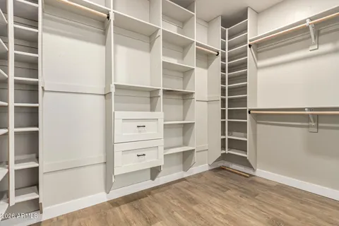 a spacious bathroom with stainless steel appliances a sink and a large mirror