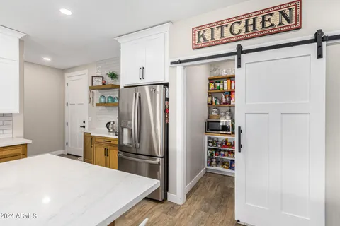 a kitchen with stainless steel appliances granite countertop a sink a stove and a refrigerator