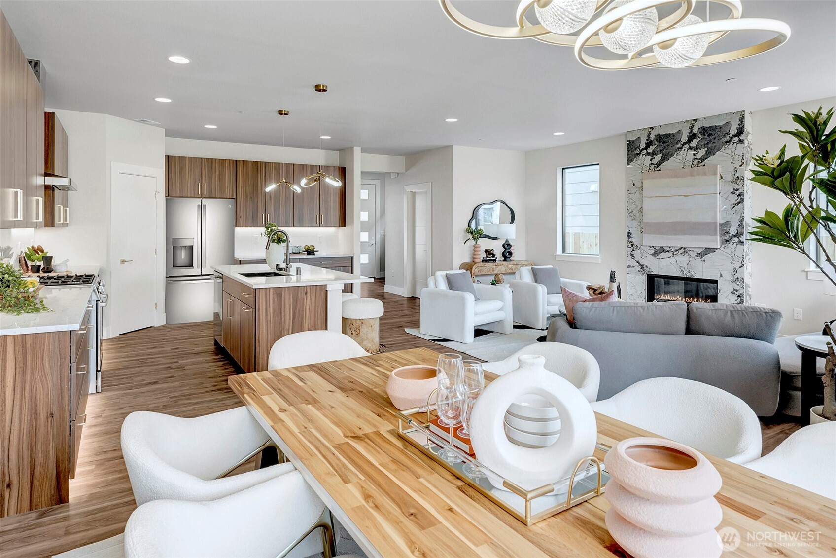 3928 214th Place Southeast, Unit B Bothell, WA 98021 - Photo 11 of 27 a living room with furniture a fireplace and a chandelier