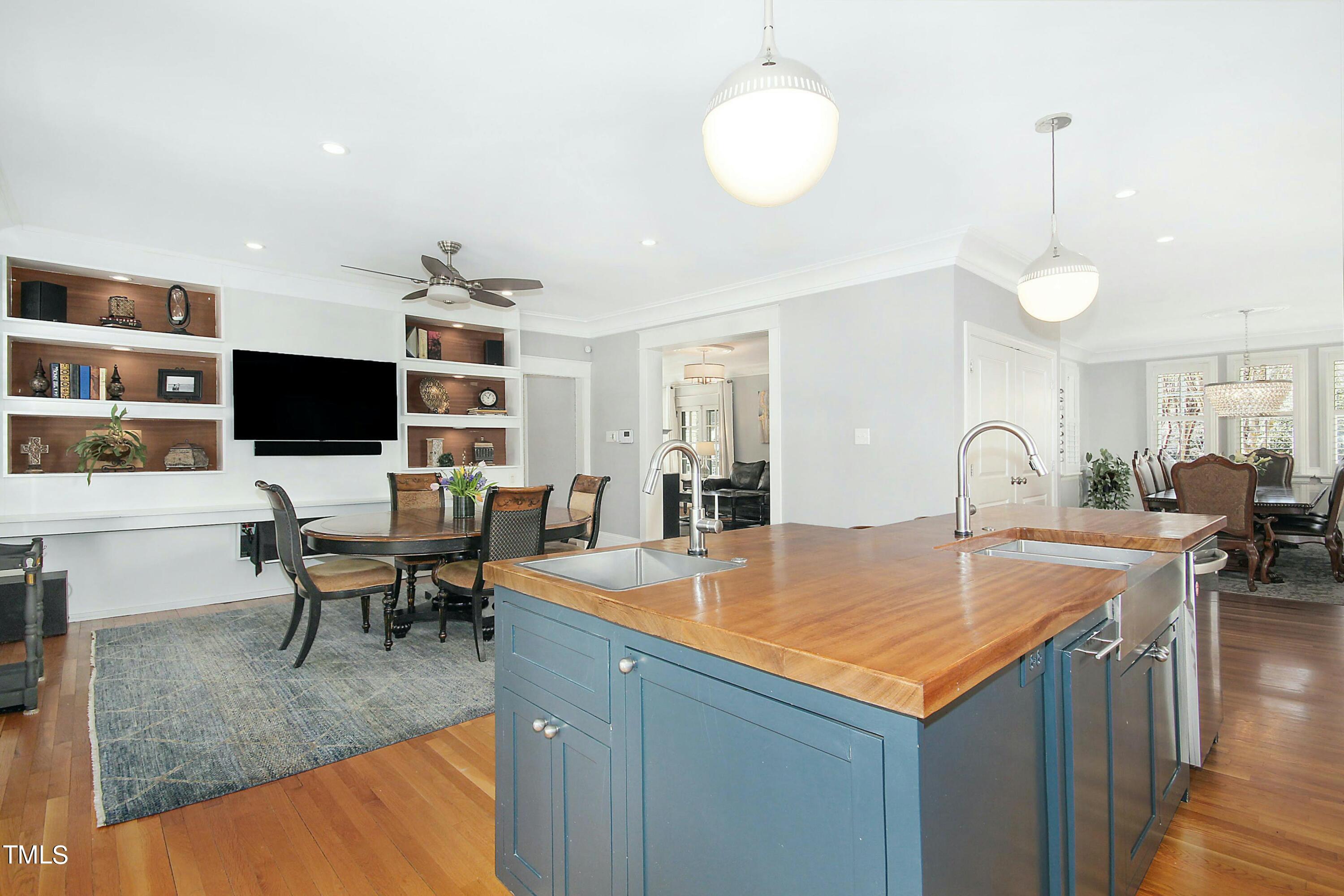 1512 Carr Street Raleigh, NC 27608 - Photo 11 of 60 a view of kitchen island a sink wooden floor and living room view