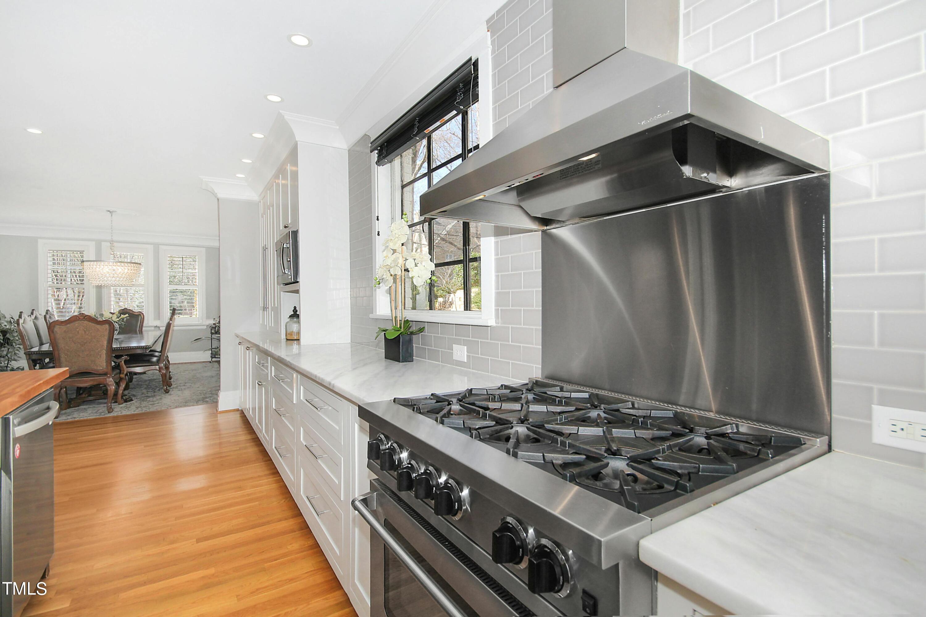 1512 Carr Street Raleigh, NC 27608 - Photo 15 of 60 a kitchen with sink stove and cabinets