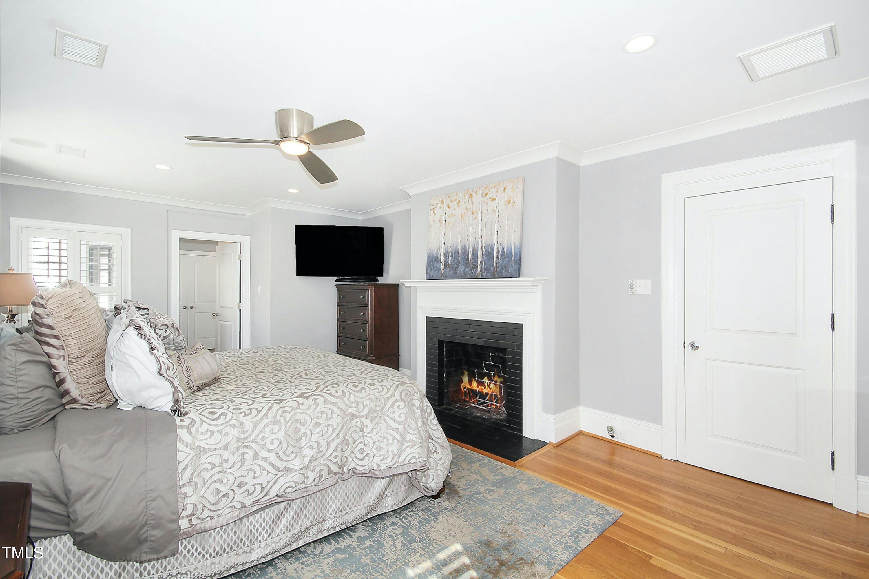 1512 Carr Street Raleigh, NC 27608 - Photo 21 of 60 a bedroom with a bed and a flat screen tv