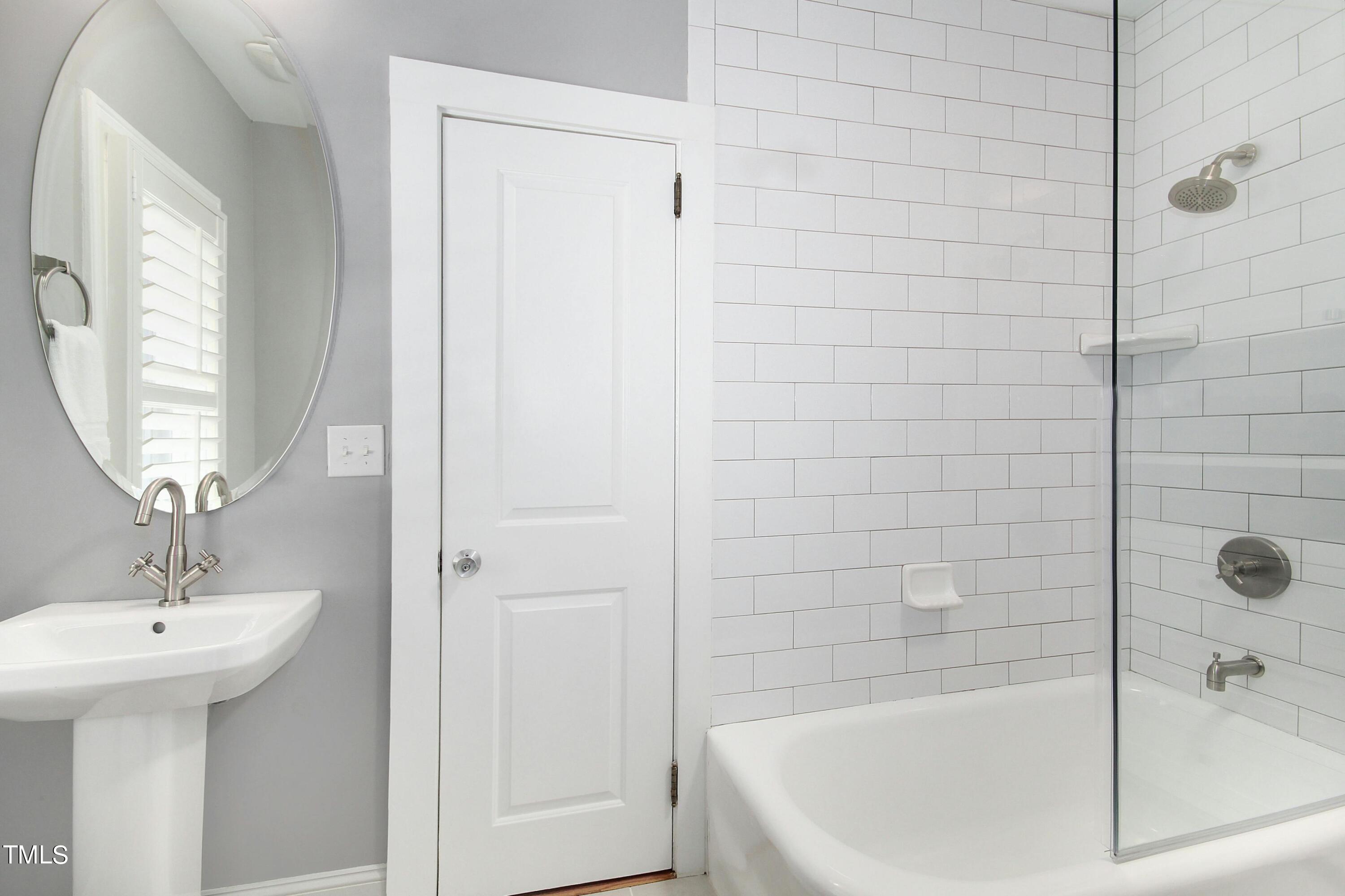 1512 Carr Street Raleigh, NC 27608 - Photo 27 of 60 a bathroom with a sink a shower and a mirror
