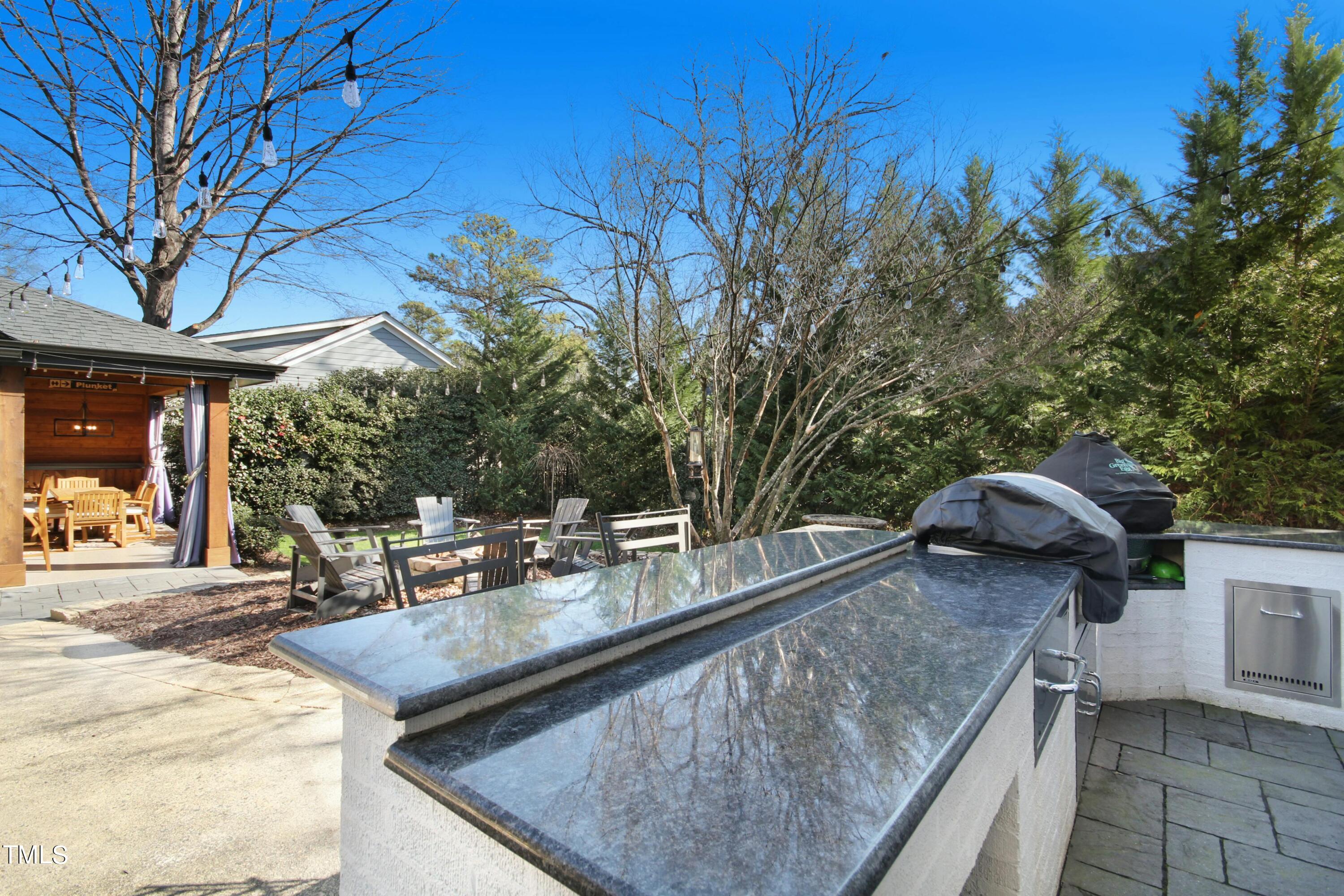 1512 Carr Street Raleigh, NC 27608 - Photo 43 of 60 a view of a patio with table and chairs and couches with wooden fence and plants