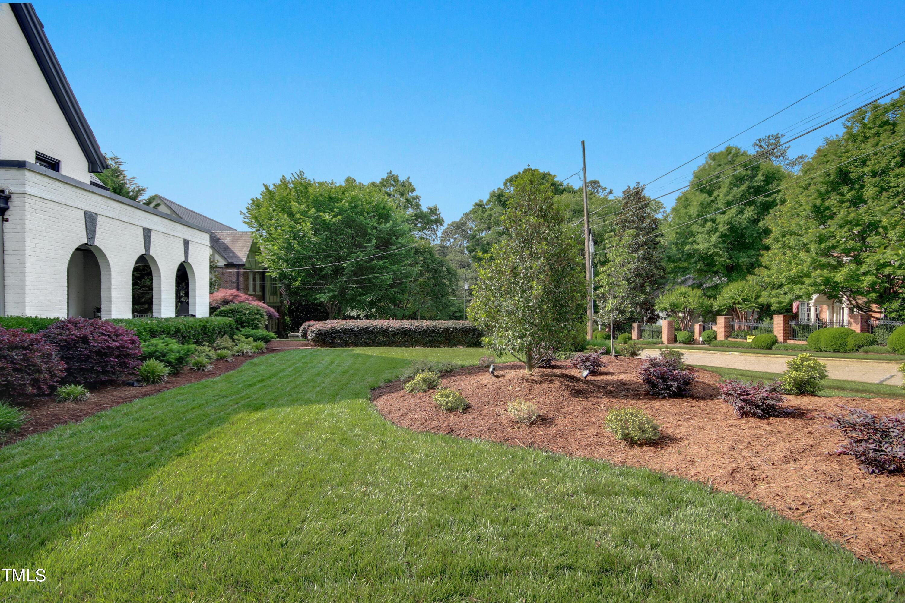 1512 Carr Street Raleigh, NC 27608 - Photo 54 of 60 a view of a white house with a big yard and large tree