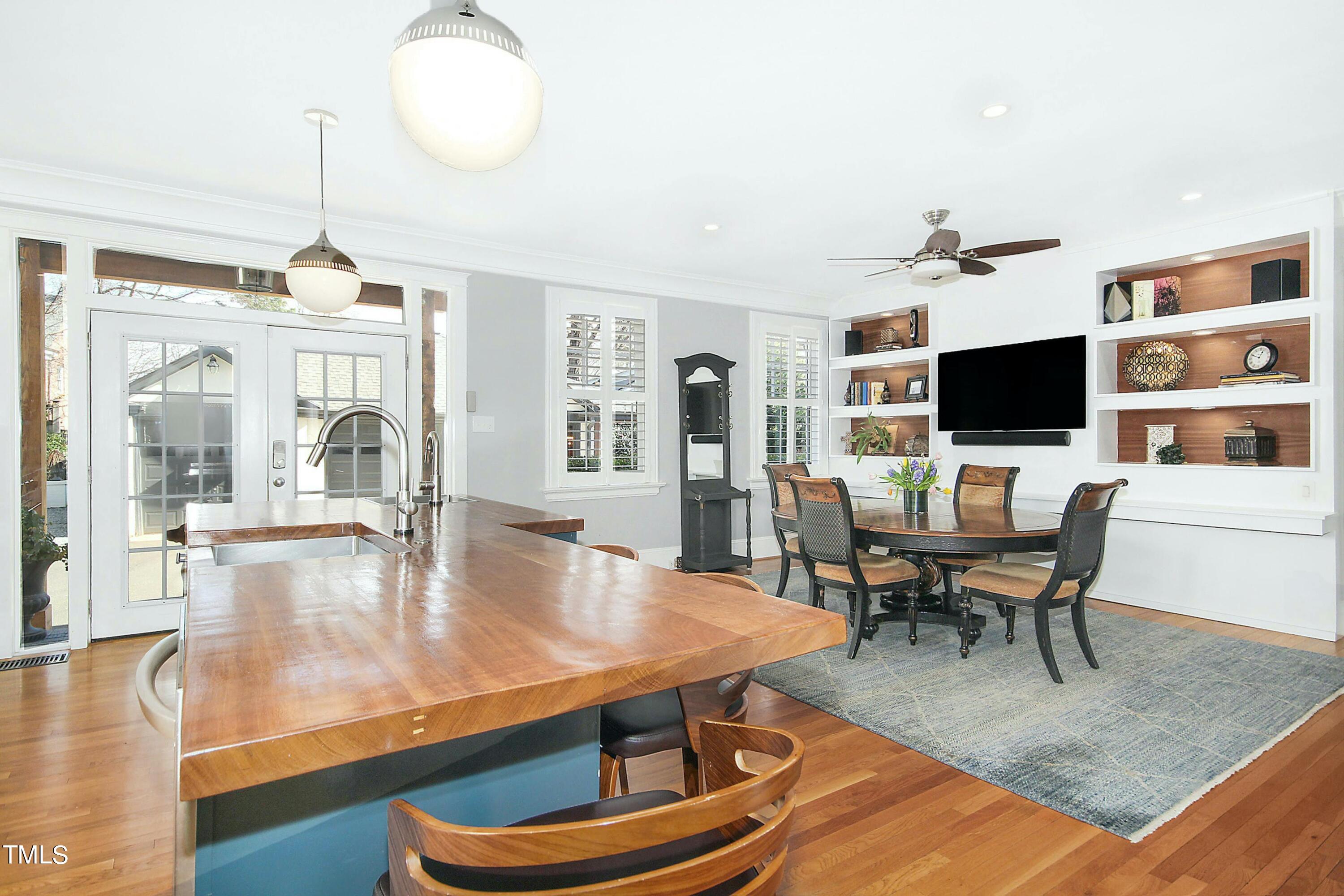 1512 Carr Street Raleigh, NC 27608 - Photo 10 of 60 a dining room with wooden floor and a chandelier