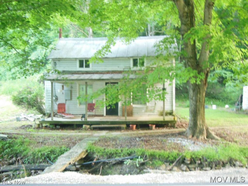 Front view of house with a small stream between the house and Rt. 31 (Shields Hill Rd.)