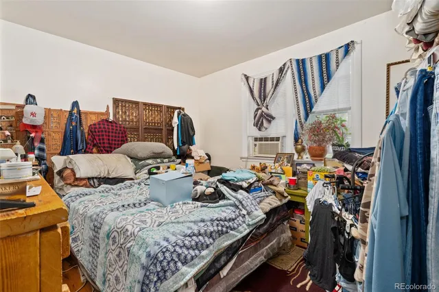 a bed room with furniture and a flat screen tv