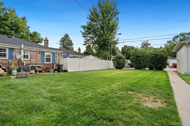 a view of a backyard with plants and a garden