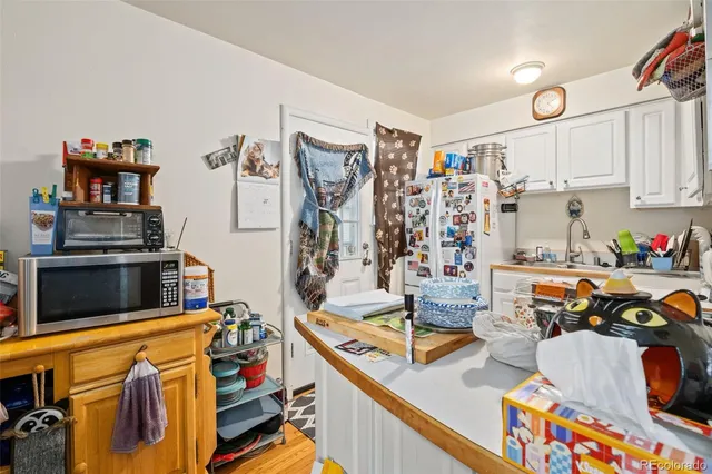 a view of a kitchen with appliances and cabinets