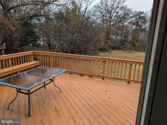 a view of balcony with wooden floor and outdoor seating