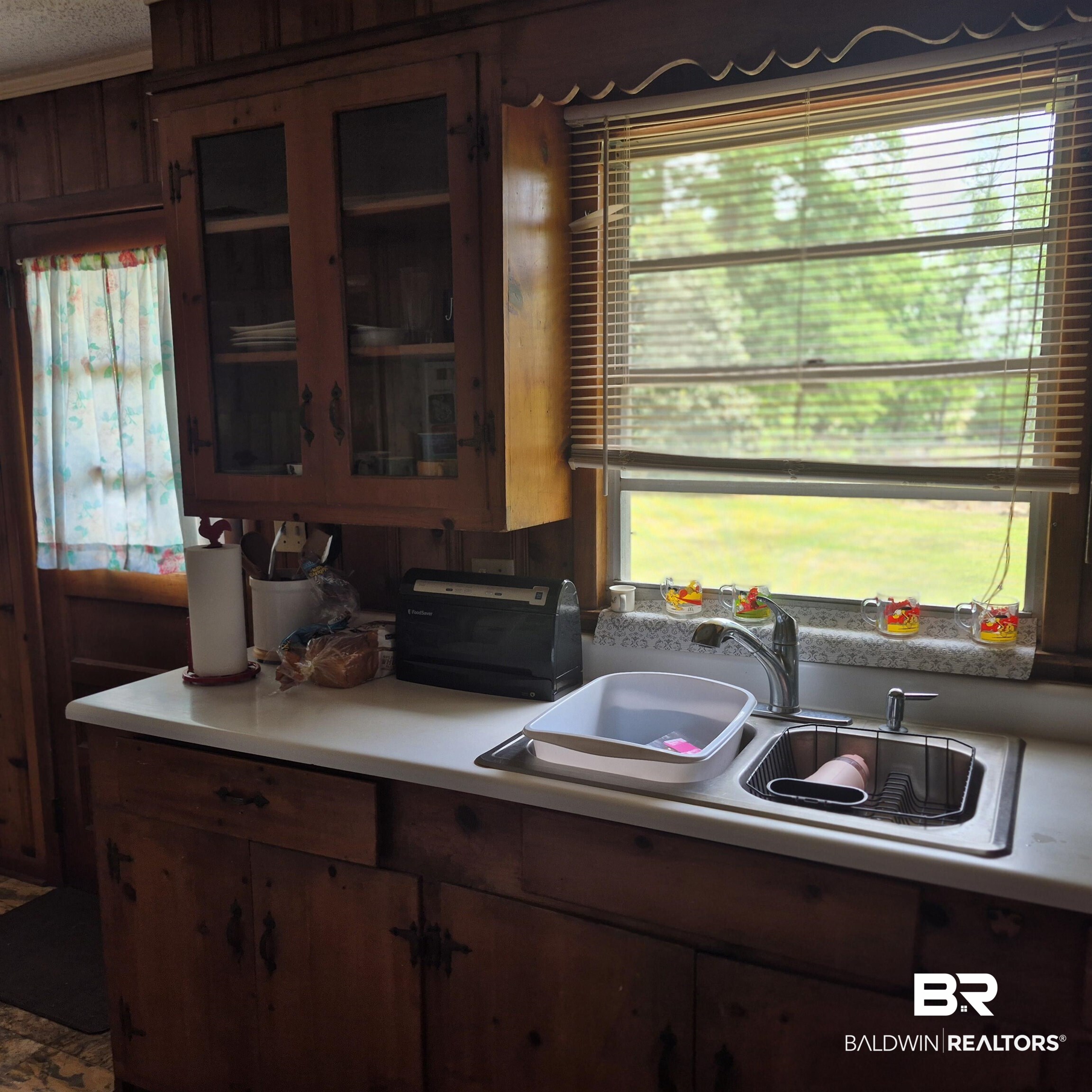 108 Azalea Street Evergreen, AL 36401 - Photo 7 of 19 Kitchen featuring wood-paneled walls and cabinetry