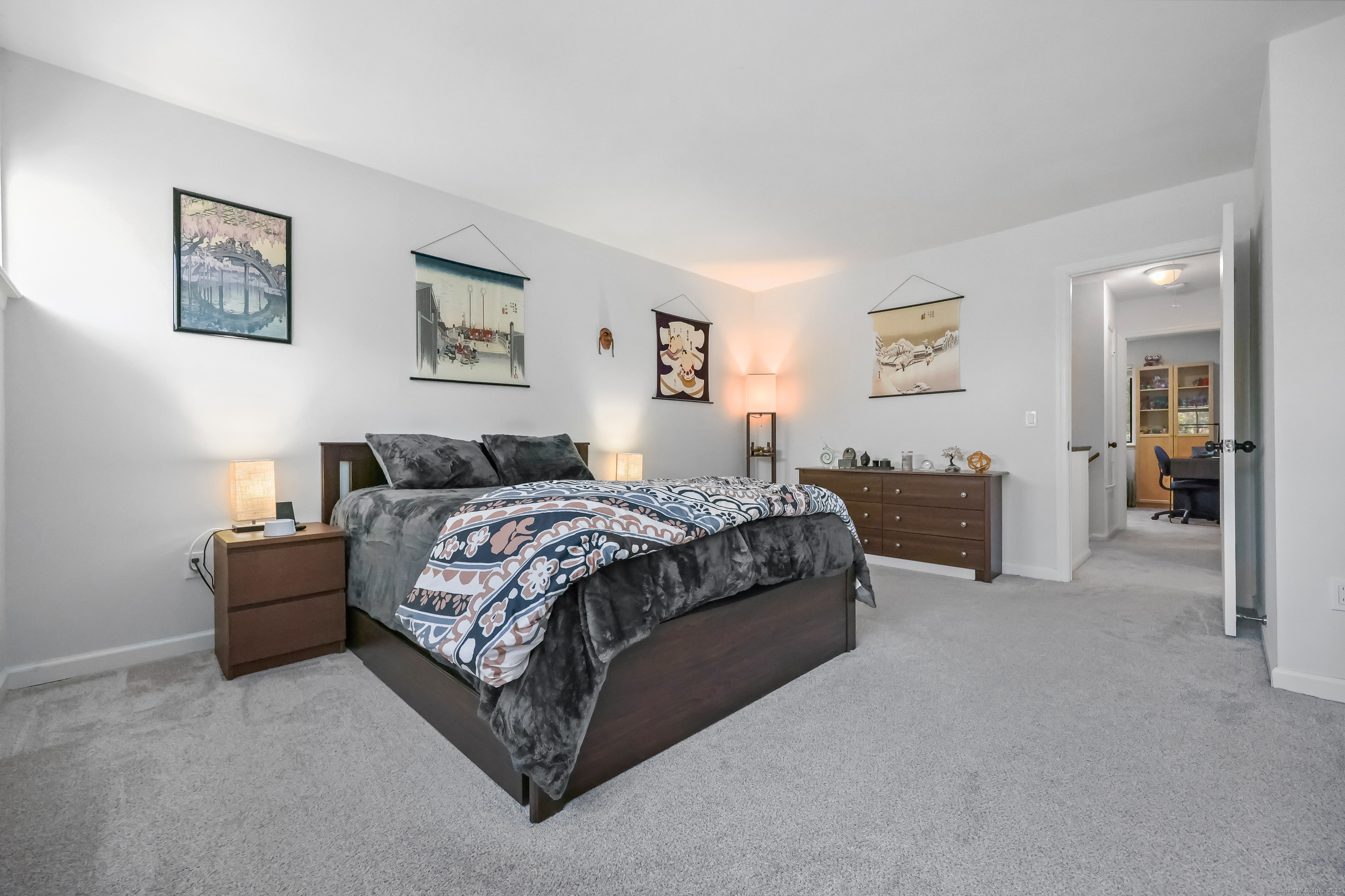 34 Sunrise Hill Road, Unit 34 Norwalk, CT 06851 - Photo 15 of 29 a spacious bedroom with a bed and painting on the wall