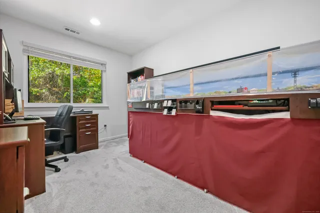 a kitchen with stainless steel appliances granite countertop a refrigerator a sink dishwasher a stove and a dining table with wooden floor