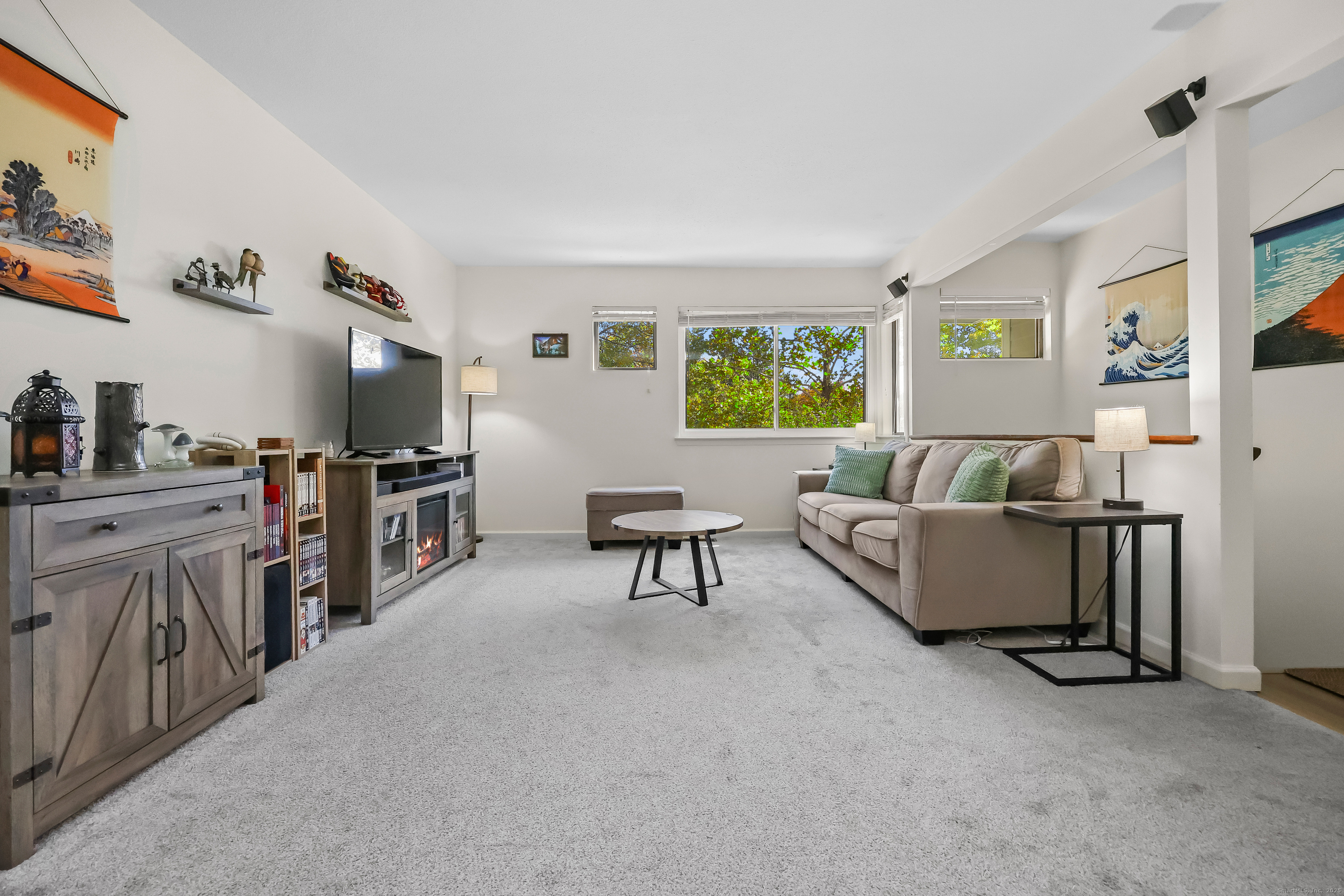 34 Sunrise Hill Road, Unit 34 Norwalk, CT 06851 - Photo 2 of 29 a living room with furniture and a flat screen tv