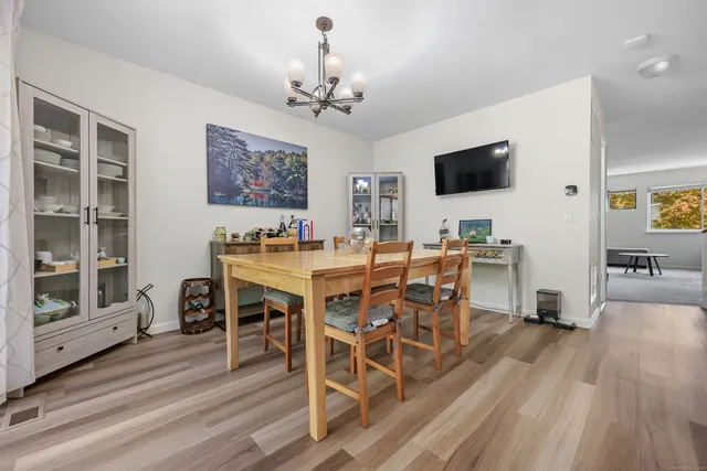 a dining room with wooden floor and breakfast area