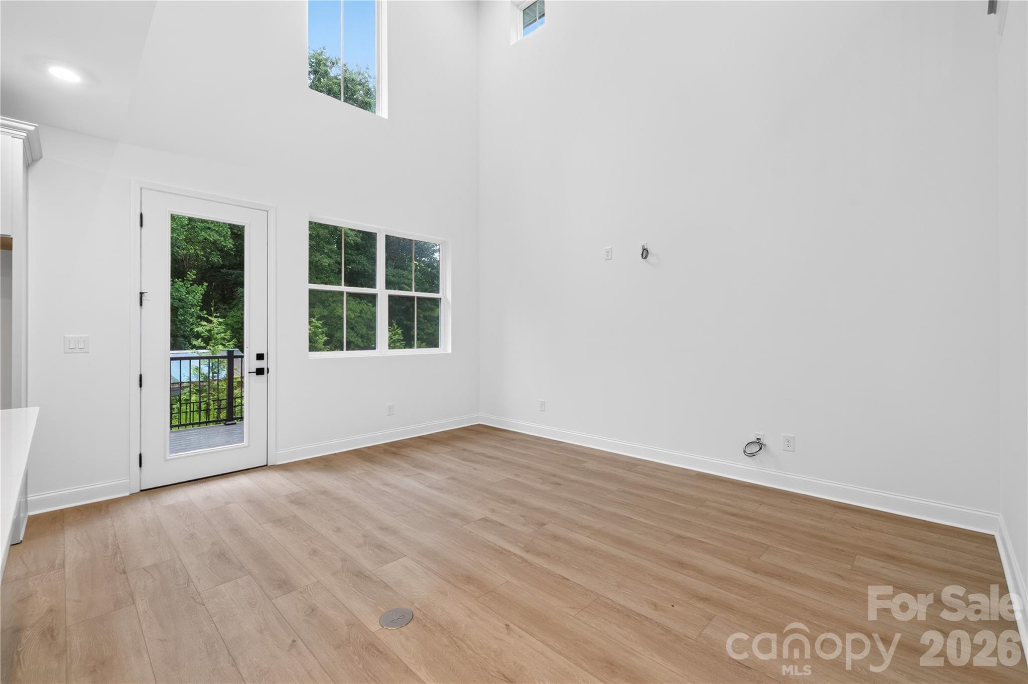 416 Celestial Drive Tega Cay, SC 29708 - Photo 8 of 21 an empty room with wooden floor and windows