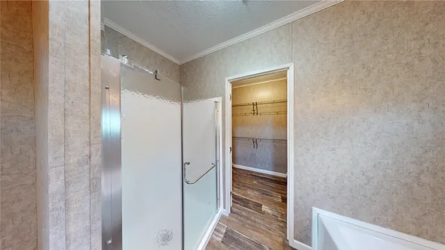 a bathroom with a glass shower door