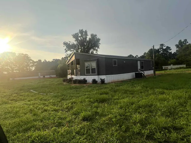 a view of a house with a backyard