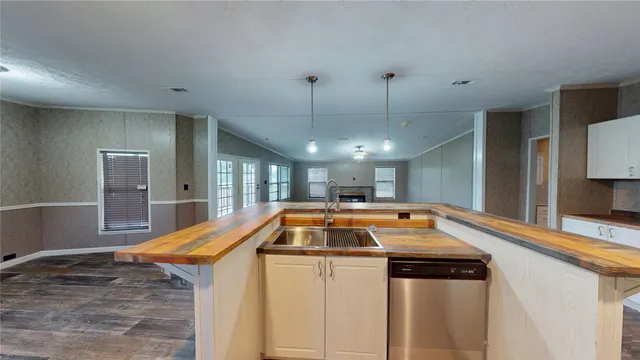 a kitchen with a sink and chandelier