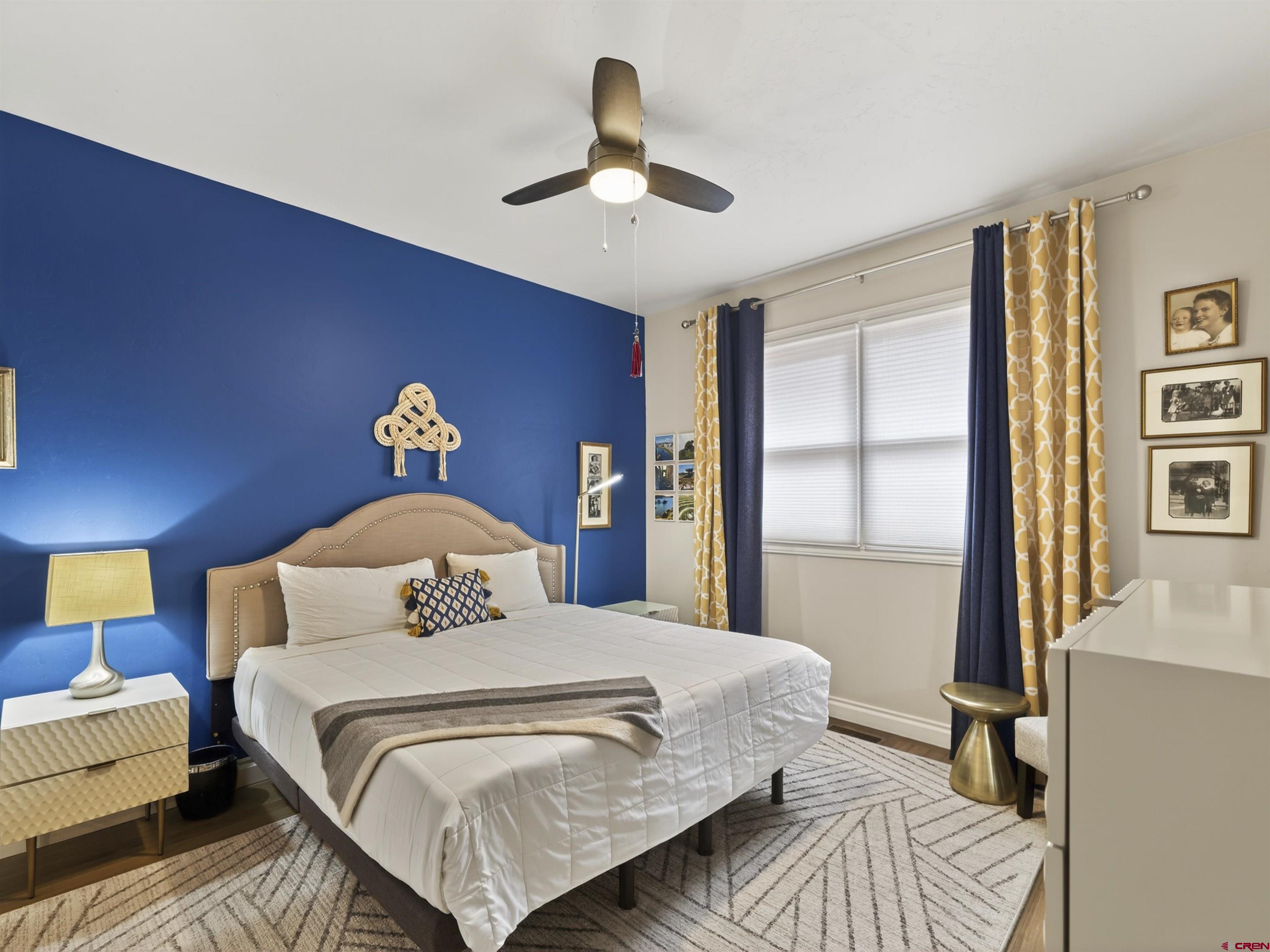 655 East 3rd Avenue Durango, CO 81301 - Photo 11 of 38 a bedroom with a large bed and a chandelier