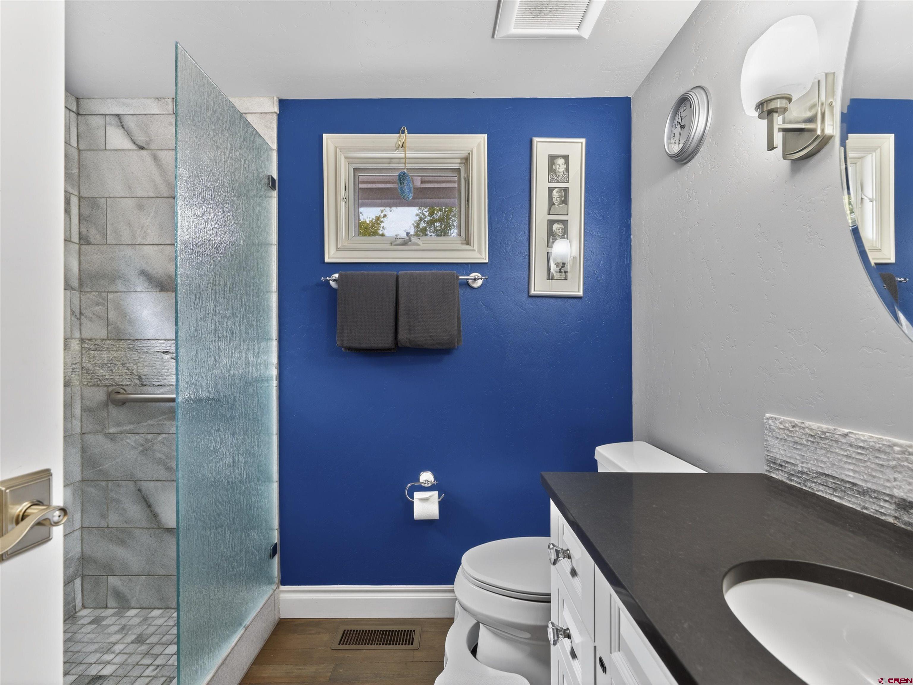 655 East 3rd Avenue Durango, CO 81301 - Photo 13 of 38 a bathroom with a granite countertop toilet sink and mirror