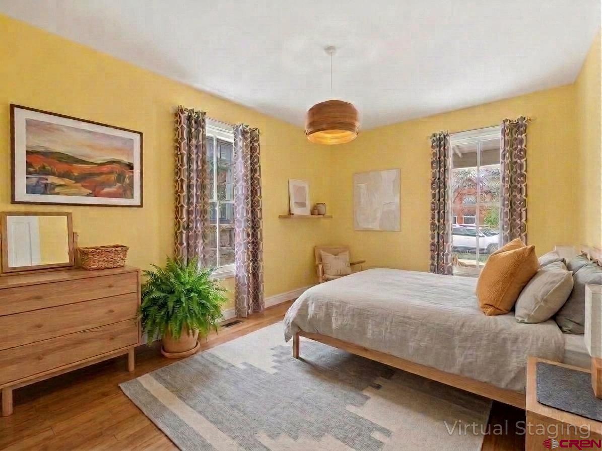 655 East 3rd Avenue Durango, CO 81301 - Photo 15 of 38 a bedroom with a bed and a painting on the wall