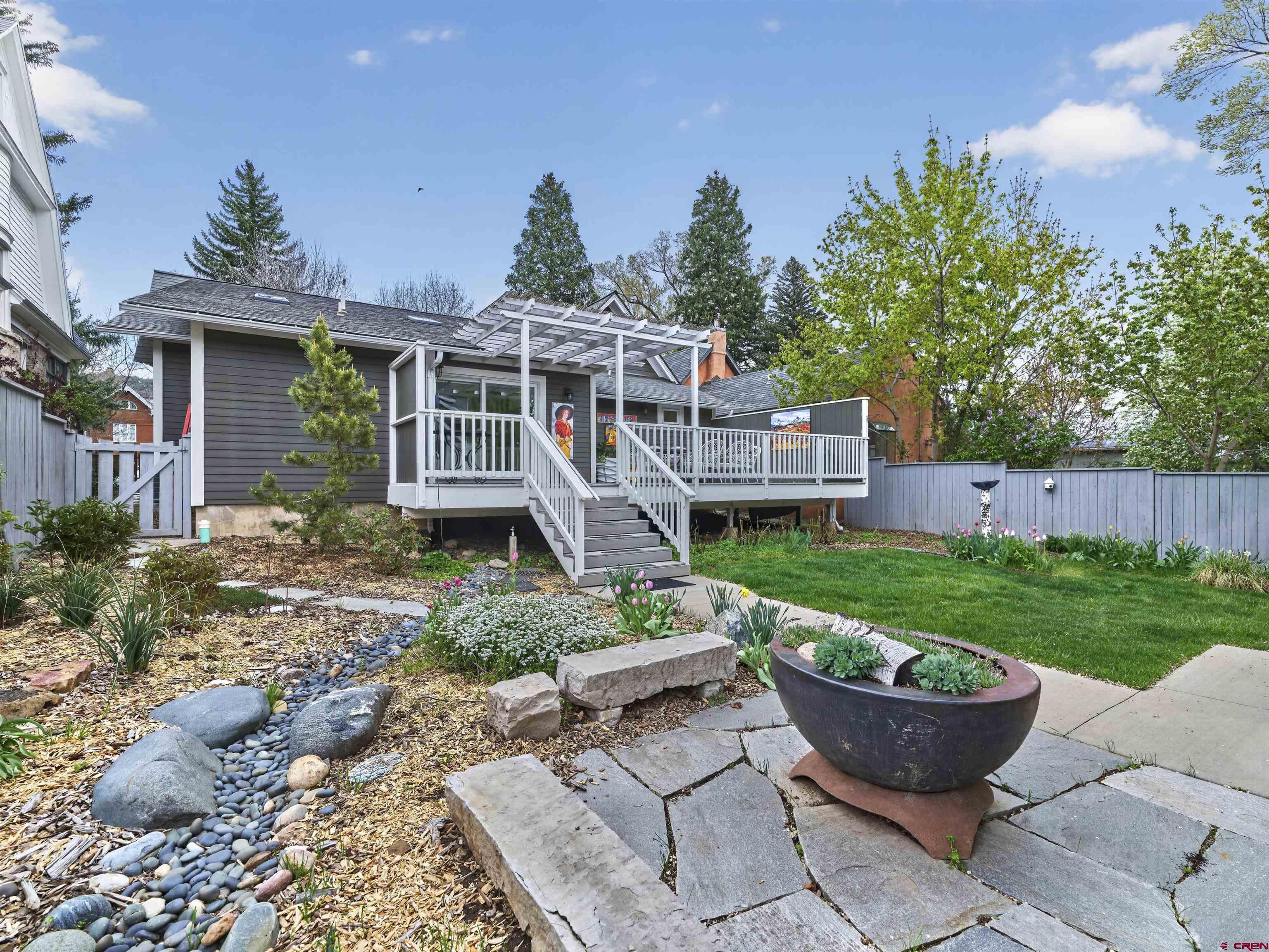 655 East 3rd Avenue Durango, CO 81301 - Photo 22 of 38 a view of a house with backyard sitting area and a garden