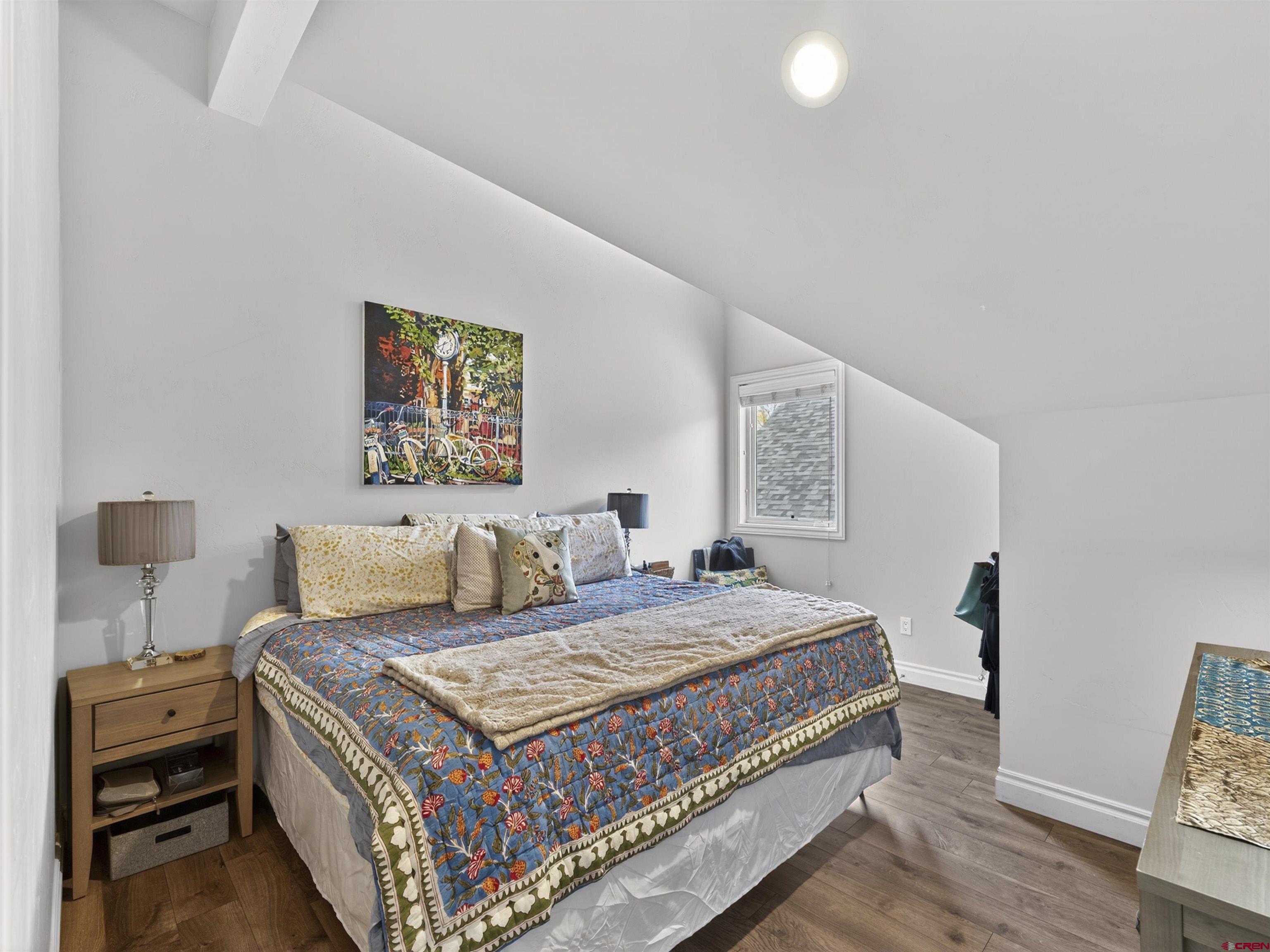 655 East 3rd Avenue Durango, CO 81301 - Photo 30 of 38 a bedroom with a bed and a lamp with the wooden floor