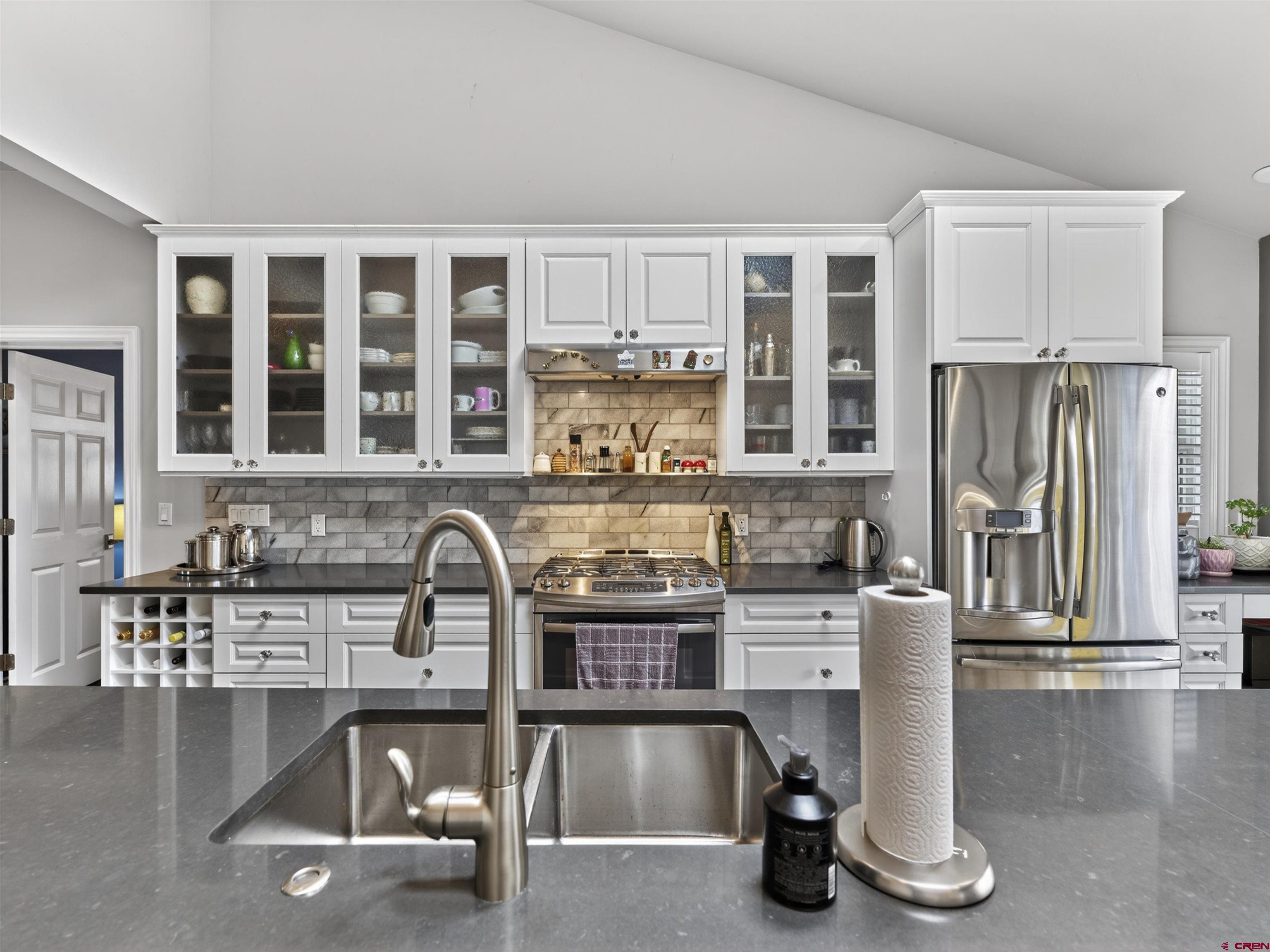 655 East 3rd Avenue Durango, CO 81301 - Photo 7 of 38 a kitchen with a refrigerator a sink and a stove