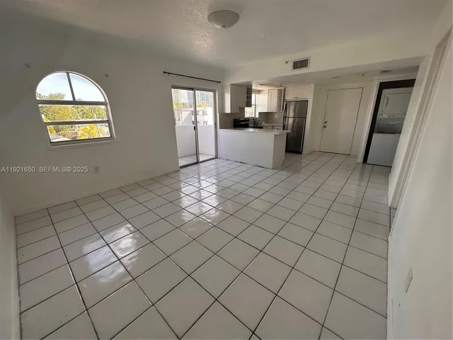 a kitchen with a stove a refrigerator and a sink