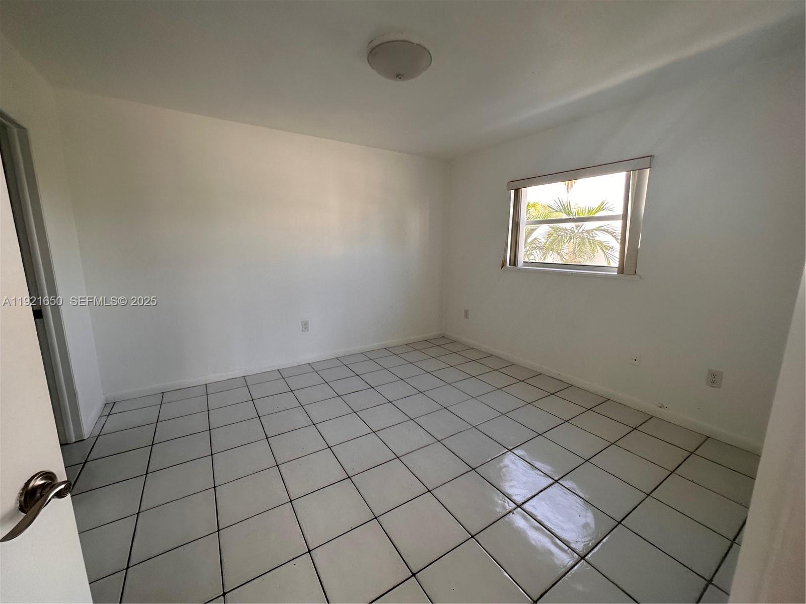 3052 Southwest 27th Avenue, Unit 301 Miami, FL 33133 - Photo 15 of 21 a view of an empty room and window