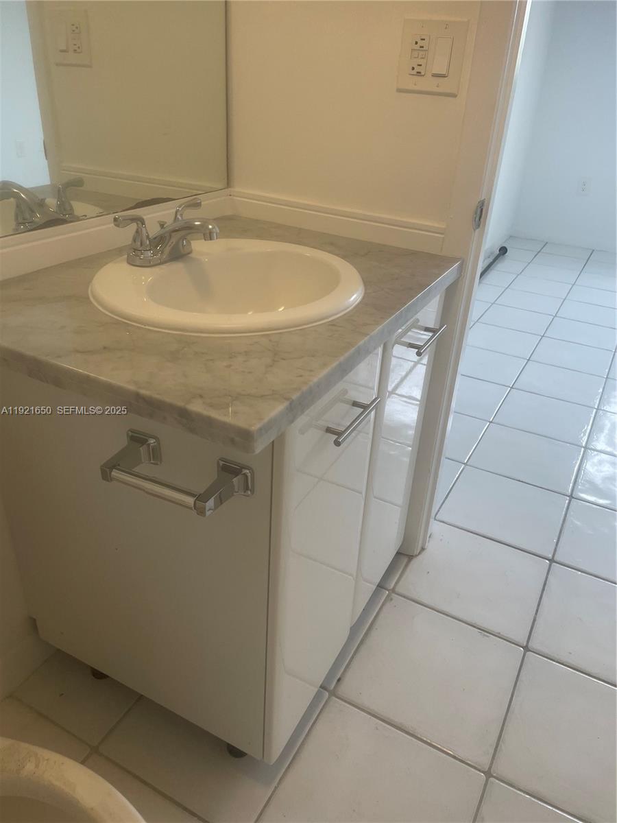3052 Southwest 27th Avenue, Unit 301 Miami, FL 33133 - Photo 19 of 21 a bathroom with a sink and shower