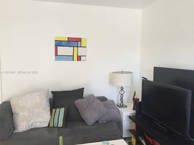 a kitchen with a stove a sink and a window