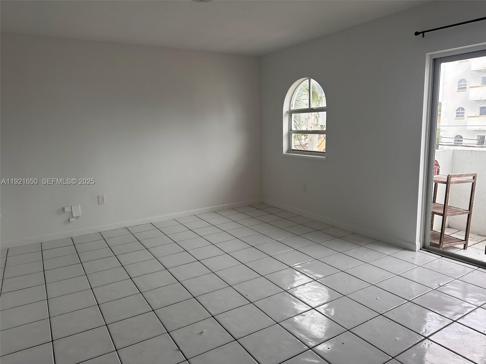 3052 Southwest 27th Avenue, Unit 301 Miami, FL 33133 - Photo 6 of 21 an empty room with windows